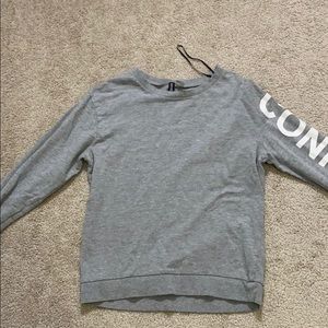Grey Long Sleeve Shirt with “Confident” on sleeve